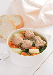 Meatball soup in white bowl