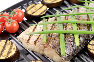 Grilled carp fillet on grill with egg plant.