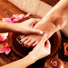 Massage of woman's foot in spa salon