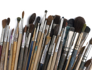 Fototapeta premium Assorted dirty old painting brushes. Isolated on white