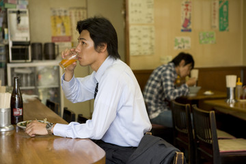 man having meal with businessman drinking beer