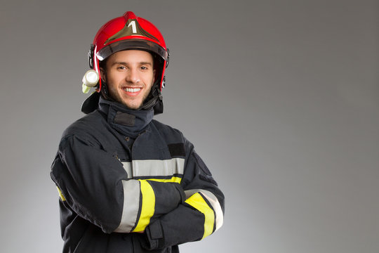 Cheerful firefighter with crossed arms.