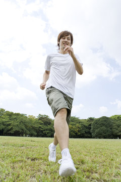 man who jogs by carrying out an earphone