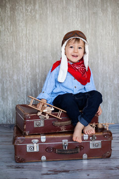 Little boy, playing with wooden plane