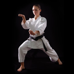 karate girl with black belt posing, champion of the world, on bl © Khorzhevska