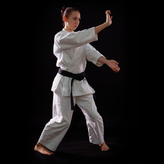 karate girl with black belt posing, champion of the world, on bl