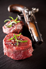 Fresh raw beef steaks on black stone