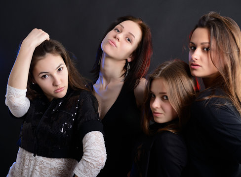 fashionable attractive party young women, over black background