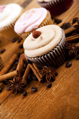 chocolate cupcake, coffee beans, cinnamon, star anise on sacking