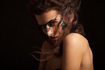 Beautiful woman with curly hair and art make-up