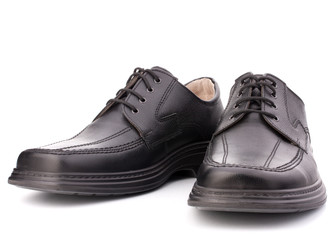 Black glossy man’s shoes with shoelaces