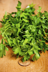 tied fresh parsley on wooden surface