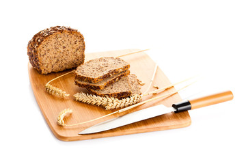 Loaf of wholemeal bread  cutting into slices on wood bread board