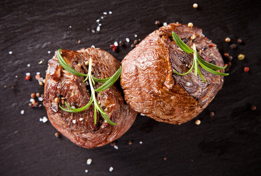 Fresh beef steaks on black stone