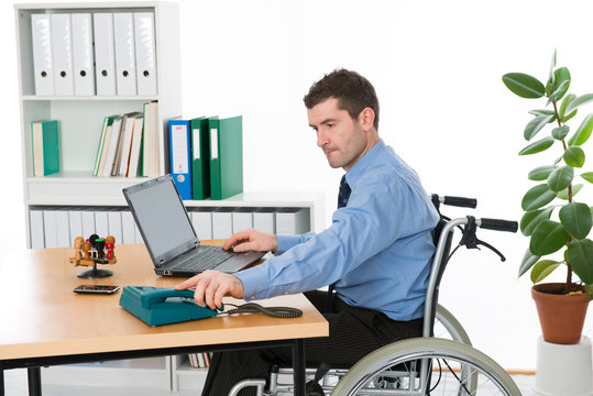man in wheelchair on workplace