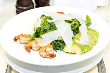 shrimp salad and greens on a white background