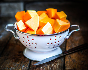 Fresh cut pumpkin on rustic wooden background