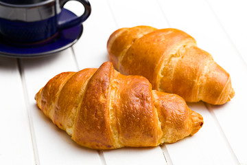 two croissants on wooden table