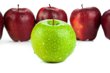 maroon apples lined up in a row and green apple closeup