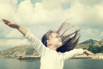 child enjoying fresh summer wind