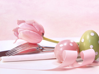 Closeup of utensils and pink tulip on pink