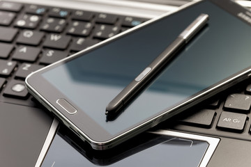 Phablet, laptop with selective focus on a stylus pen