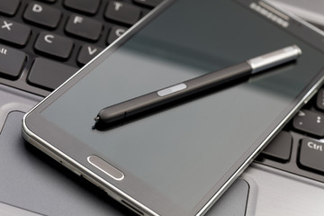 Phablet, laptop with selective focus on a stylus pen