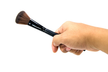 Makeup brush in a hand on white background