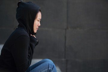 unhappy woman sit outdoor