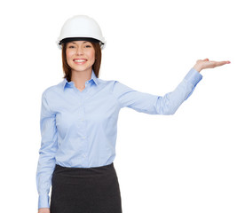 businesswoman in helmet holding something on palm