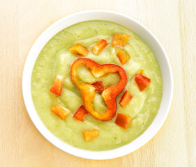 vegetable puree garnished with red pepper in white bowl