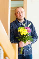  man with   bouquet near   door
