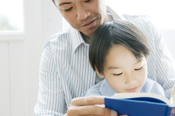 father and son reading book