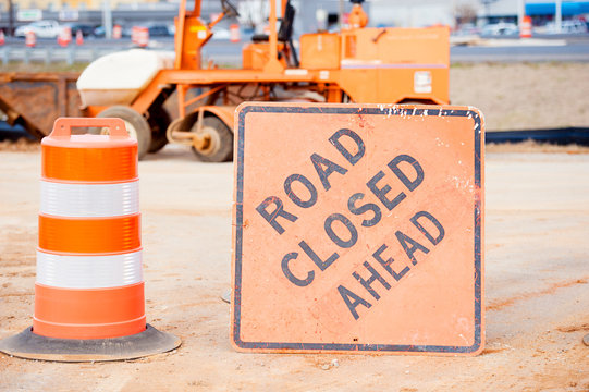 orange road closed sign at construction site