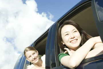 two women leaning out from car window