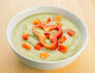 vegetable puree garnished with red pepper in white bowl