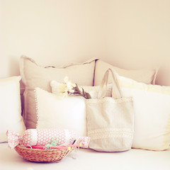 Knitting needles in basket and cute tote bag on the bed with ret