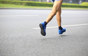 marathon runner legs running on street
