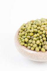 Green mung beans in bowl on white background