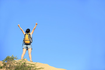 cheering hiking woman open arms desert mountain peak