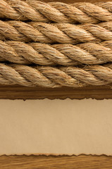 Fototapeta na wymiar ropes and old paper at wood