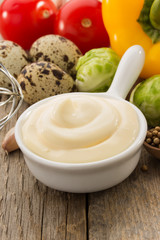 mayonnaise sauce in bowl on wood