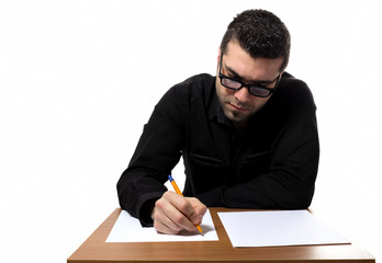 Young man filling forms and papers like taking an exam.
