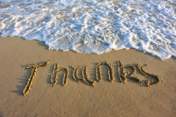 thanks word drawn on beach