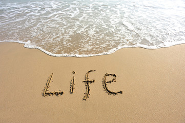life word drawn on beach