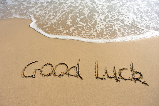 good luck word drawn on beach