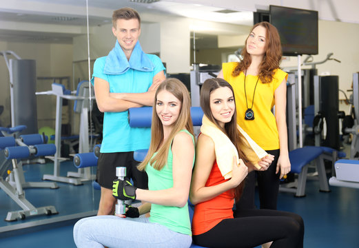 Group of people relaxing after training in gym