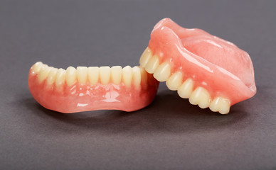 A set of dentures on a gray background