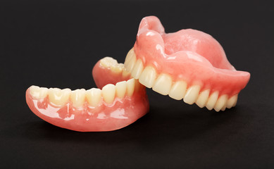 A set of dentures on a black background