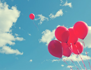 Bunch of red ballons on a blue sky - Powered by Adobe